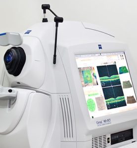 Optical coherence tomography imaging machine displaying scan results on its screen